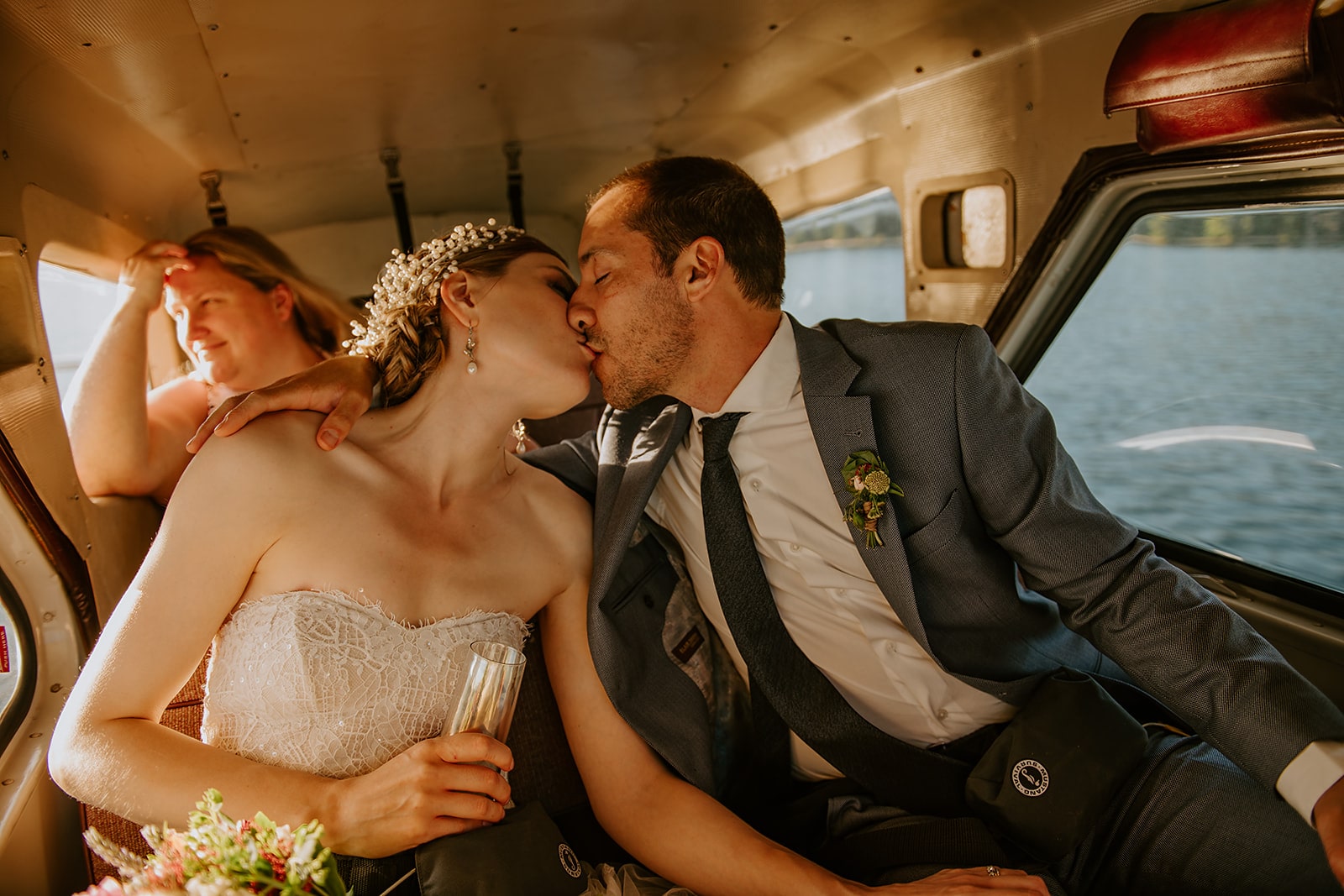 bride and groom kissing in plane