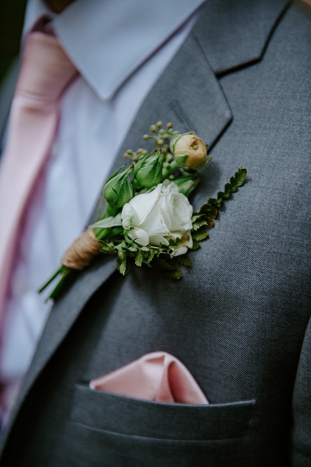 Grooms boutonniere with white rose